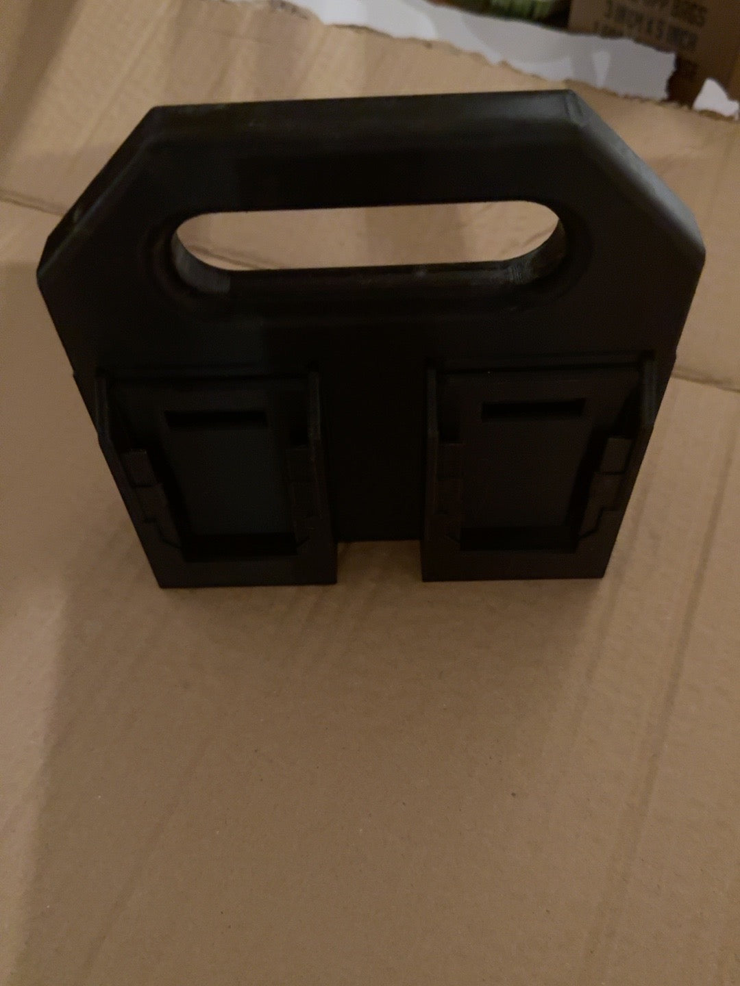 Black PETG four-battery caddy compatible with DEWALT 20V MAX-style batteries, empty front view