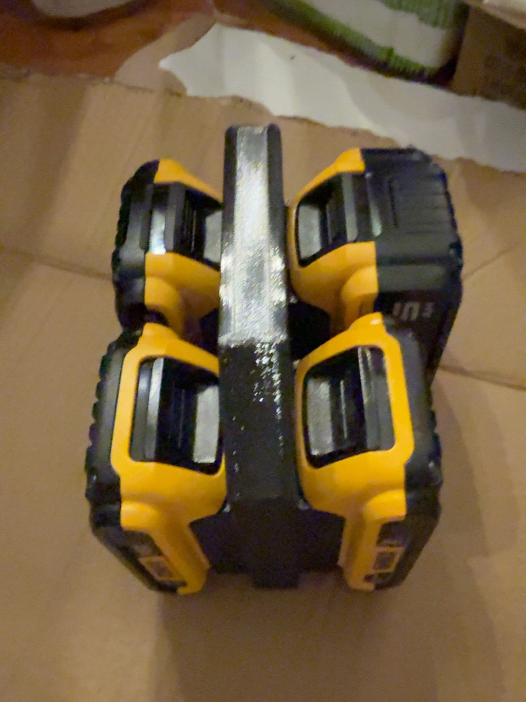 Black PETG four-battery caddy compatible with DEWALT 20V MAX-style batteries, loaded with four batteries, top view