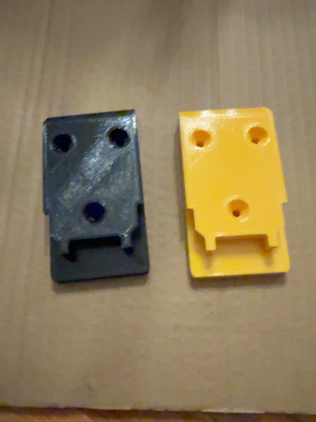 Black and yellow PETG tool mounts with clip compatible with DEWALT 20V MAX-style tools, front view
