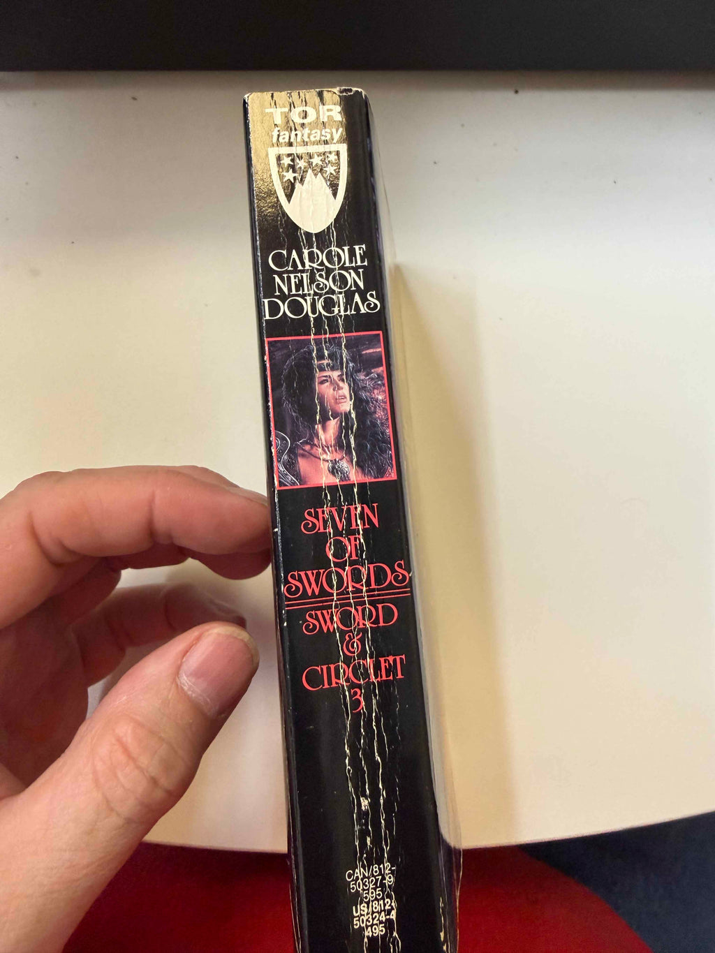 Spine of actual Seven of Swords showing heavy creases