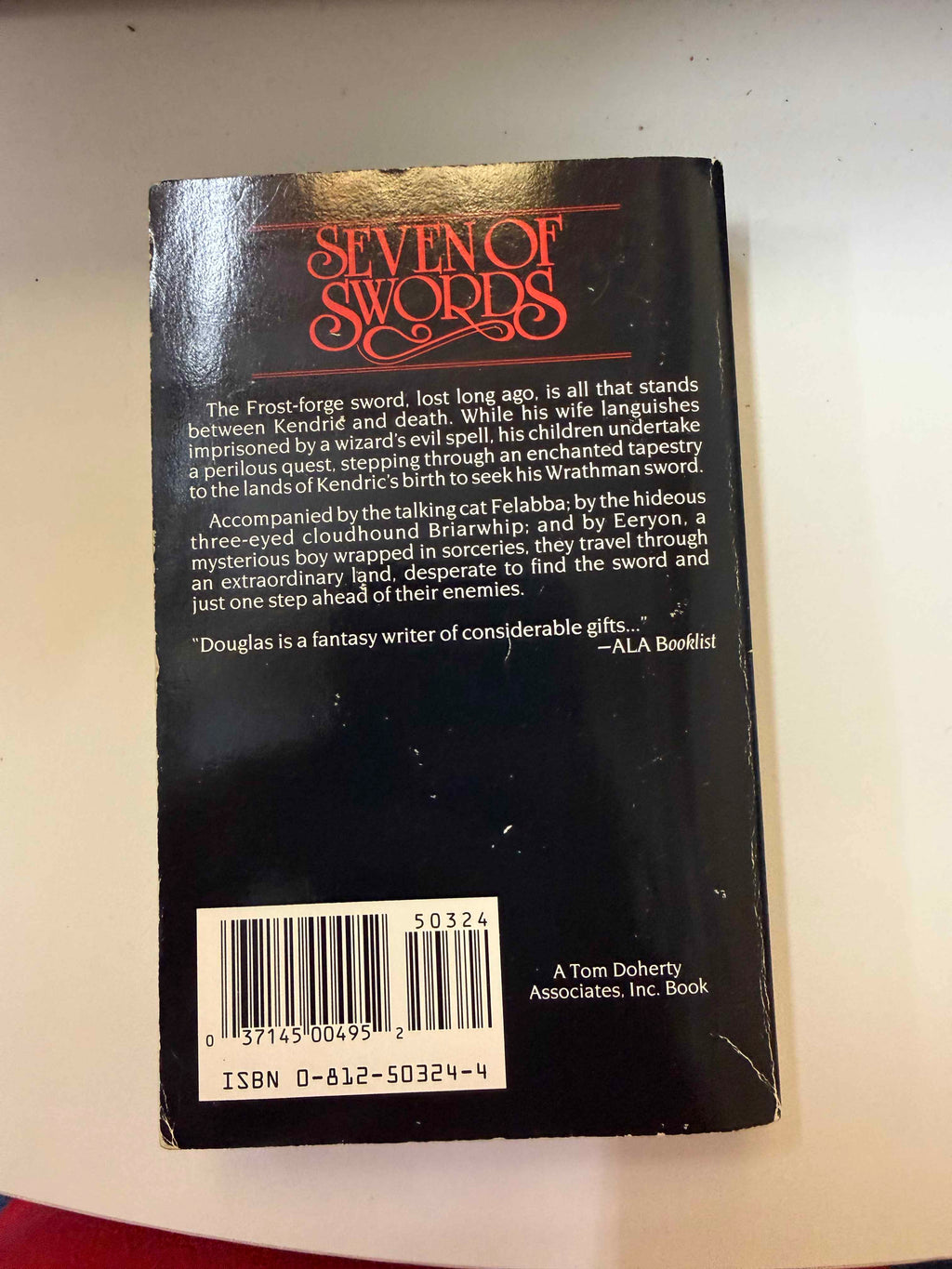 Back cover of actual Seven of Swords showing barcode and ISBN